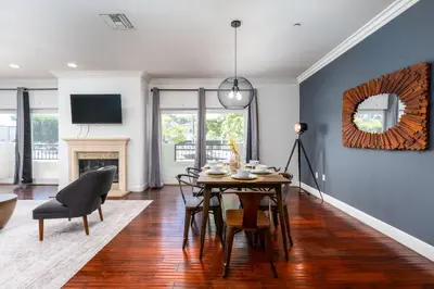 a dining room with a table and chairs and a fireplace at Stylish Home Prime Location with Fireplace & Patio in Los Angeles