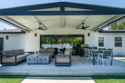 a patio with furniture and tables and chairs at Luxury Summer Getaway in Encino in Van Nuys Airport