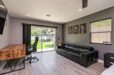 a living room with a leather couch and a desk at Luxury Summer Getaway in Encino in Van Nuys Airport
