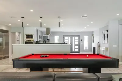 a living room with a red pool table at Luxury Summer Getaway in Encino in Van Nuys Airport