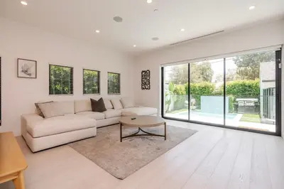 a living room with a couch and a table at Modern Poolside Paradise in Sherman Oaks
