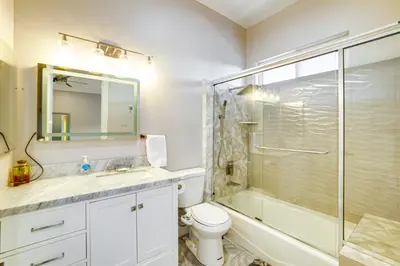 a bathroom with a shower and a toilet and a sink at Expansive Riverside Mansion! Luxe, Family Friendly in Riverside