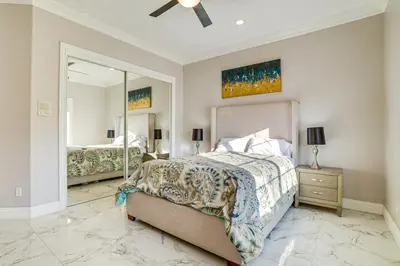 a bedroom with a bed and a large mirror at Expansive Riverside Mansion! Luxe, Family Friendly in Riverside