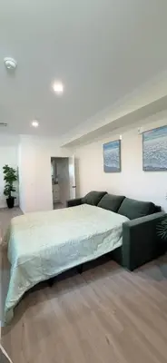 a bedroom with a large bed and a couch at Luxurious Pasadena Home w Parking & Near Old Town in Pasadena