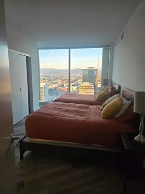 a bedroom with a large bed with a large window at 2 Bedroom with City Views in Los Angeles