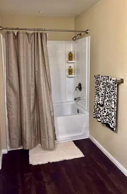 a bathroom with a bath tub with a shower curtain at The Luxe Marina HideAway in Los Angeles