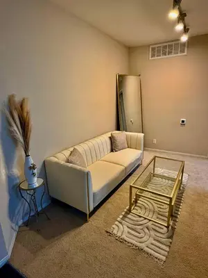 a living room with a couch and a glass table at The Luxe Marina HideAway in Los Angeles