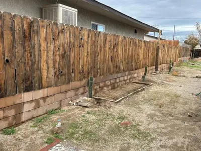 a wooden fence in front of a house at Desert Oasis Retreat in Barstow in Barstow
