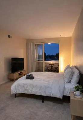 a bedroom with a large bed and a television at Demo2 in Los Angeles