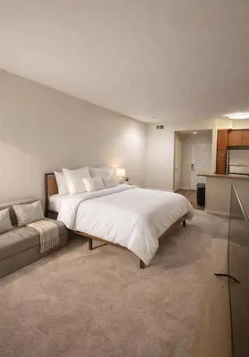 a bedroom with a large white bed and a couch at Demo2 in Los Angeles