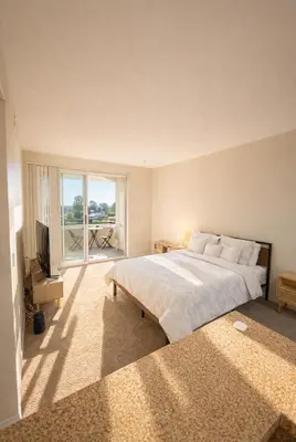 a bedroom with a large bed and a large window at Demo3 in Los Angeles