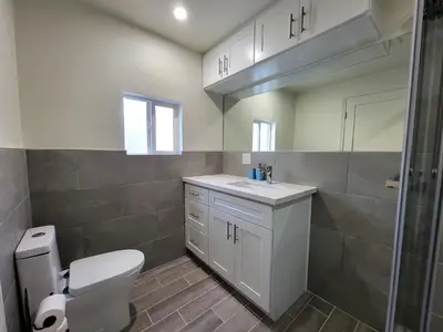 a bathroom with a toilet and a sink and a shower at Modern 2BR Guest Suite w En-Suite Bathrooms 10 min to Rodeo Drive Near Kaiser and Cedars hospitals in Los Angeles