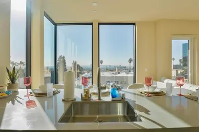 a kitchen with a sink and large windows at LA Hype Spot Sunset x Fairfax SkyView in Los Angeles