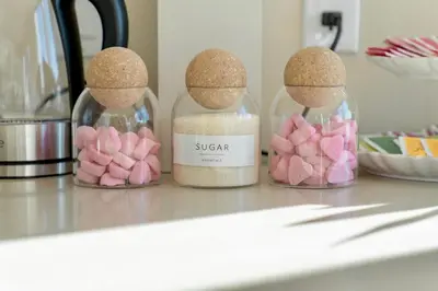 three glass jars filled with pink marshmallows on a counter at LA Hype Spot Sunset x Fairfax SkyView in Los Angeles