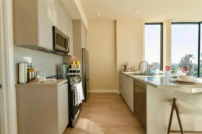 a kitchen with white cabinets and a counter top at LA Hype Spot Sunset x Fairfax SkyView in Los Angeles
