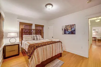 a bedroom with a bed and a lamp on a table at Home half Mi to Dtwn Riverside Families Welcome! in Riverside