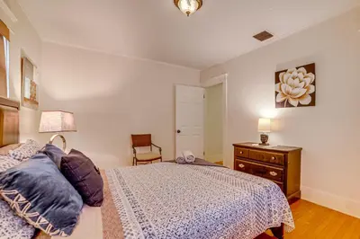a bedroom with a bed and a dresser and a lamp at Home half Mi to Dtwn Riverside Families Welcome! in Riverside