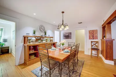 a dining room with a wooden table and chairs at Home half Mi to Dtwn Riverside Families Welcome! in Riverside