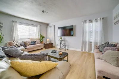 a living room with two couches and a table at Family-Friendly Home 2 Mi to Dtwn Riverside in Riverside