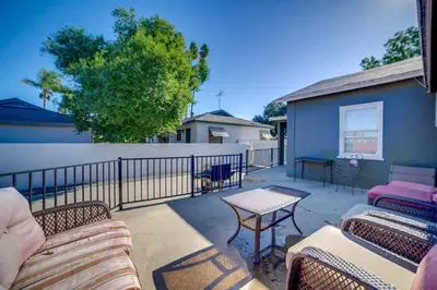 a patio with chairs and tables and a fence at Family-Friendly Home 2 Mi to Dtwn Riverside in Riverside