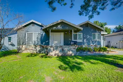 a large blue house with a yard at Family-Friendly Home 2 Mi to Dtwn Riverside in Riverside