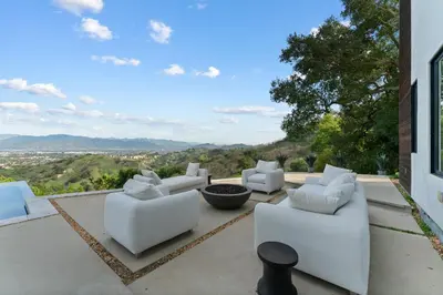 a group of white couches sitting on a patio at Mulholland Edition in Beverly Hills