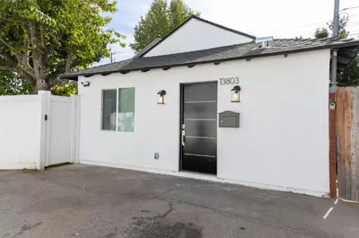 a white garage with a black door at Stellar Sherman Oaks One Bedroom close to Universal Studios in Burbank