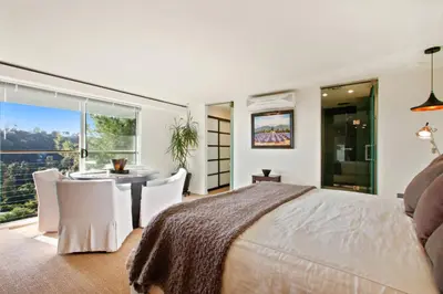 a bedroom with a bed and a table and chairs at The Beverly Aura in Los Angeles