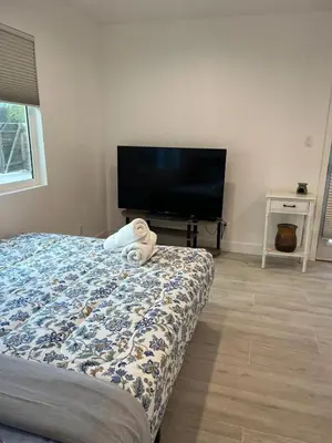 a bedroom with a bed and a flat screen tv at Brand New Home, Great Location, Monthly Discounts in Woodland Hills