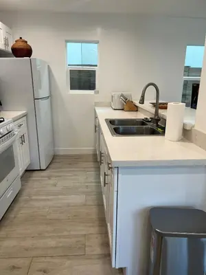 a kitchen with a sink and a refrigerator at Brand New Home, Great Location, Monthly Discounts in Woodland Hills