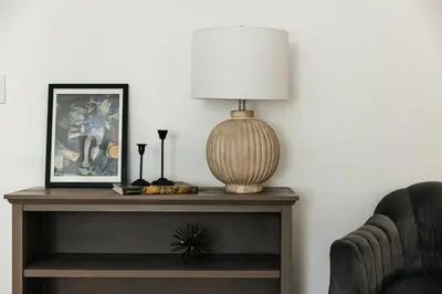 a lamp on a table next to a chair at Serene Urban Haven in Los Angeles