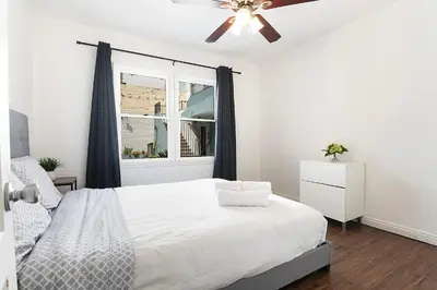 a white bedroom with a bed and a window at Affordable 1BR apt near Beverly Hills in Los Angeles