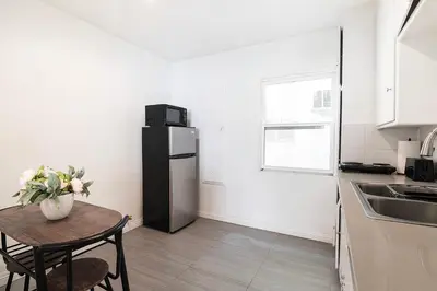 a kitchen with a small table and a refrigerator at Affordable 1BR apt near Beverly Hills in Los Angeles
