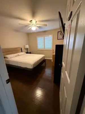 a bedroom with a bed and a ceiling fan at Peaceful Room in Riverside