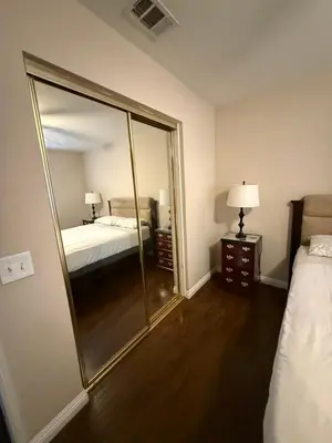 a large mirror in a bedroom with a bed and a bed sqor at Peaceful Room in Riverside