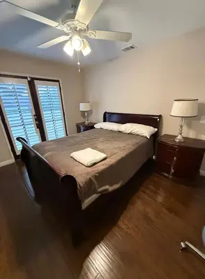 a bedroom with a bed and a ceiling fan at Peaceful Room in Riverside