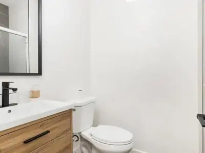 a white bathroom with a toilet and a sink at Holiday Home Modern Home by Interhome in Westminster