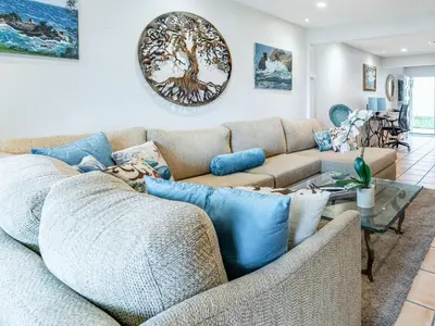 a living room with a couch and a table at Apartment Meerblick Eigentumswohnung gegenüber dem Strand by Interhome in Port Hueneme