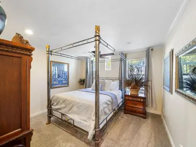 a bedroom with a four poster bed and a dresser at Holiday Home Haus mit Seeblick - Atemberaubende Aussicht - Haustierfreundlich by Interhome in Lake Arrowhead