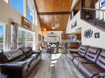 a living room with leather furniture and a wooden ceiling at Holiday Home Haus mit Seeblick - Atemberaubende Aussicht - Haustierfreundlich by Interhome in Lake Arrowhead