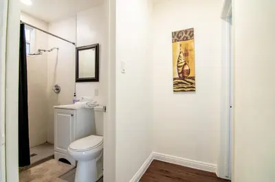 a white bathroom with a toilet and a shower at Relaxing 1 Bedroom Suite Near Beverly Hills in Los Angeles