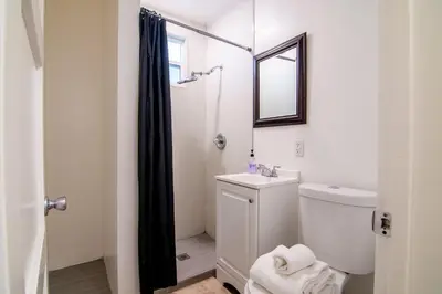 a bathroom with a toilet and a sink and a mirror at Relaxing 1 Bedroom Suite Near Beverly Hills in Los Angeles