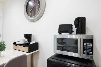 a microwave with a phone on top of it at Cozy Studio Suite Near Beverly Hills in Los Angeles