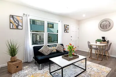 a living room with a couch and a table at Cozy Studio Suite Near Beverly Hills in Los Angeles