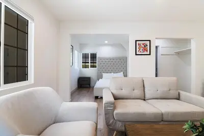 a living room with a couch and a bed at Freshly Renovated Studio for Two in the Heart of LA in Los Angeles