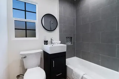 a bathroom with a toilet and a sink and a tub at Freshly Renovated Studio for Two in the Heart of LA in Los Angeles