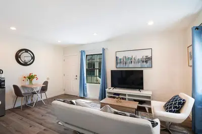 a living room with a couch and a tv at Upper-Level Studio Suite Close to Beverly Hills in Los Angeles