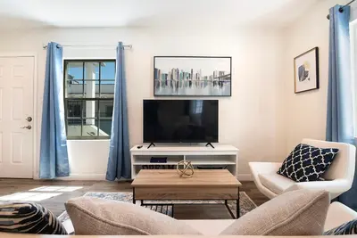 a living room with a tv and a couch and a table at Upper-Level Studio Suite Close to Beverly Hills in Los Angeles
