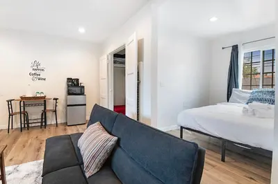 a living room with a bed and a couch at Cozy Studio Suite Near Beverly Hills for Two in Los Angeles
