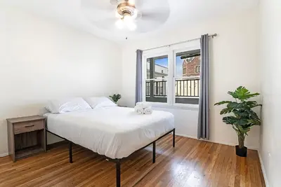 a white bedroom with a bed and a window at Affordable One-Bedroom Close to Pico and Beverly Hills in Los Angeles